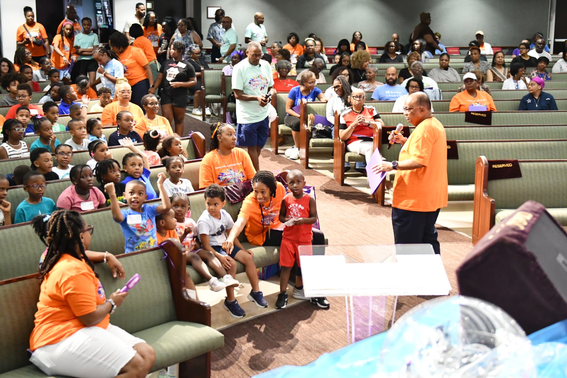 Local youth ministry gathering at Shiloh — children, volunteers, and families in the sanctuary